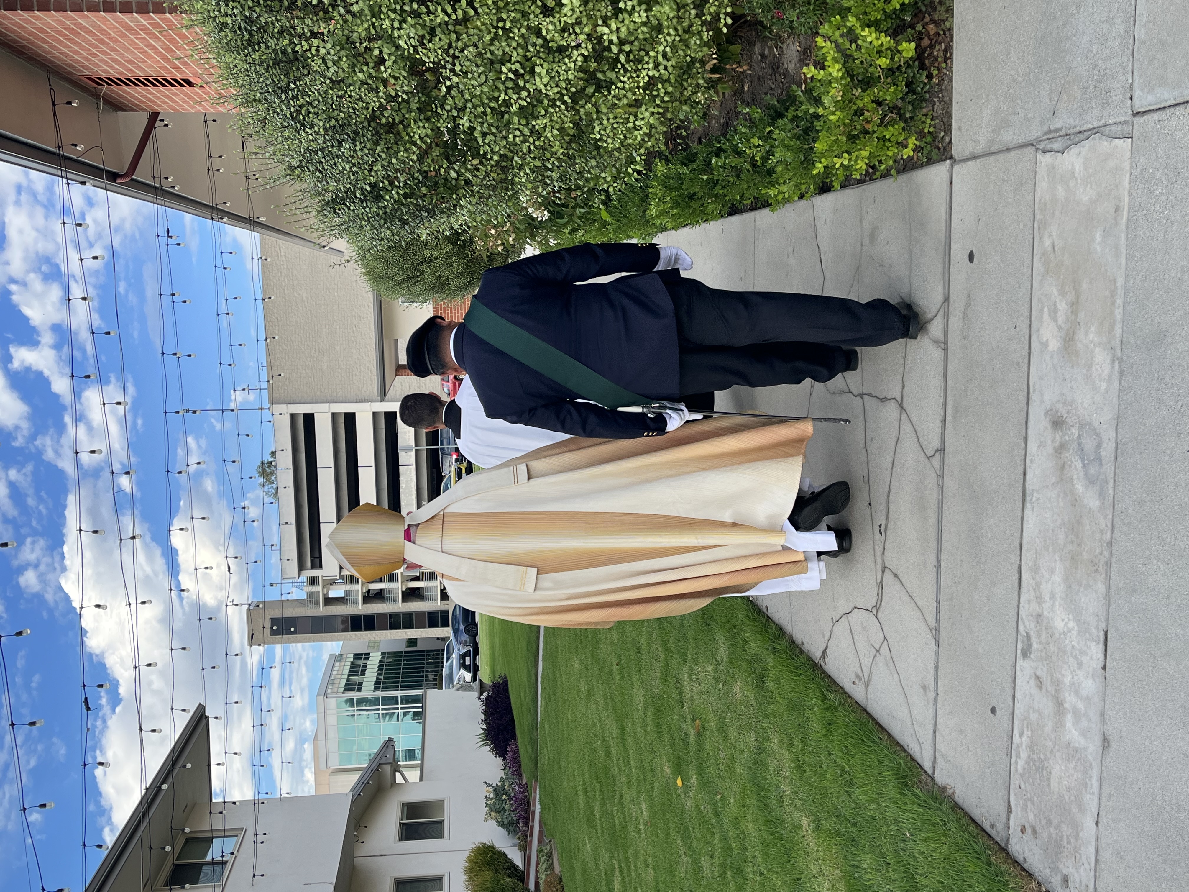 Archbishop José H. Gomez walking beside a Knight of Columbus member on the parish grounds